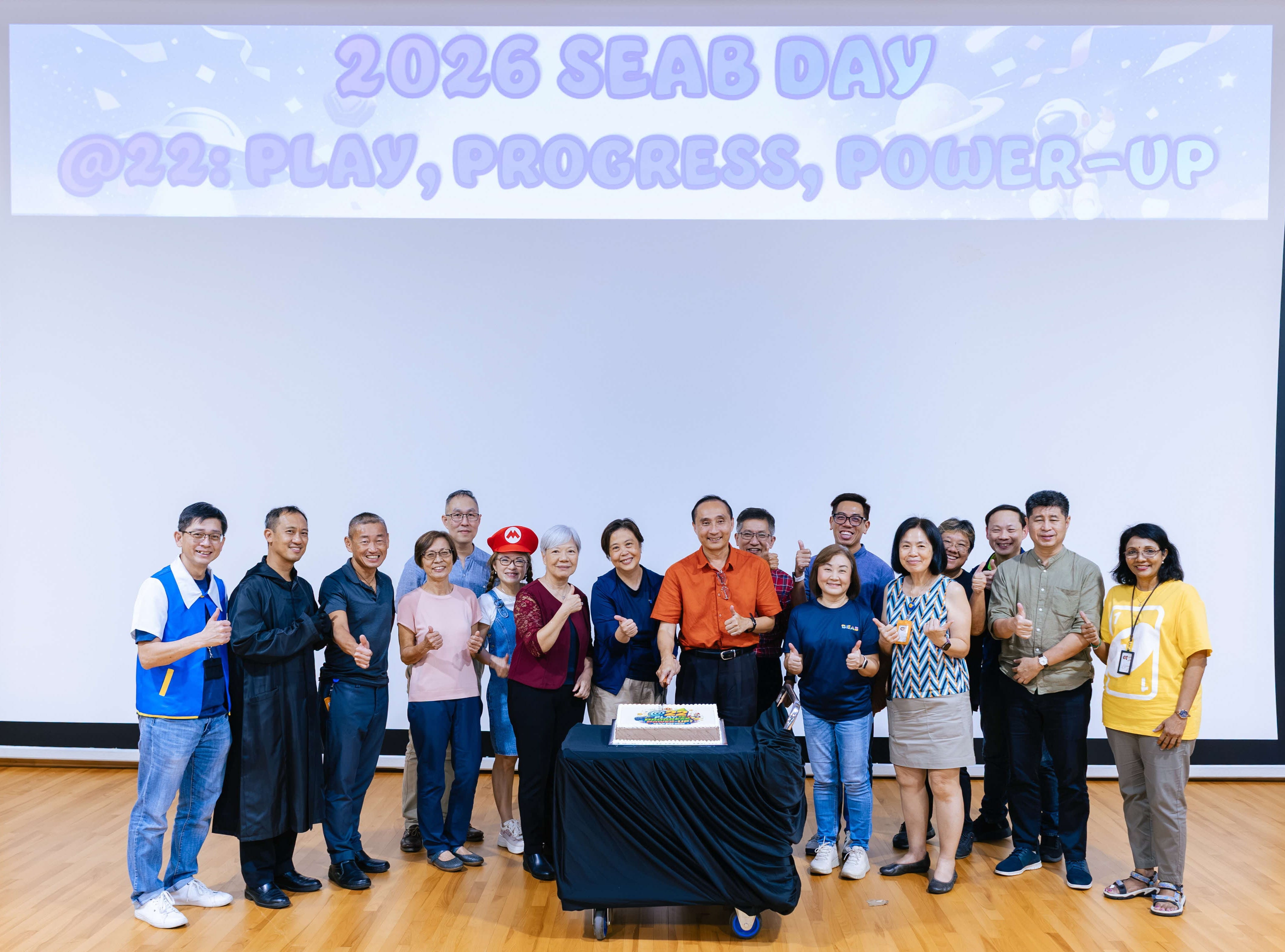 Group photo of management with birthday cake